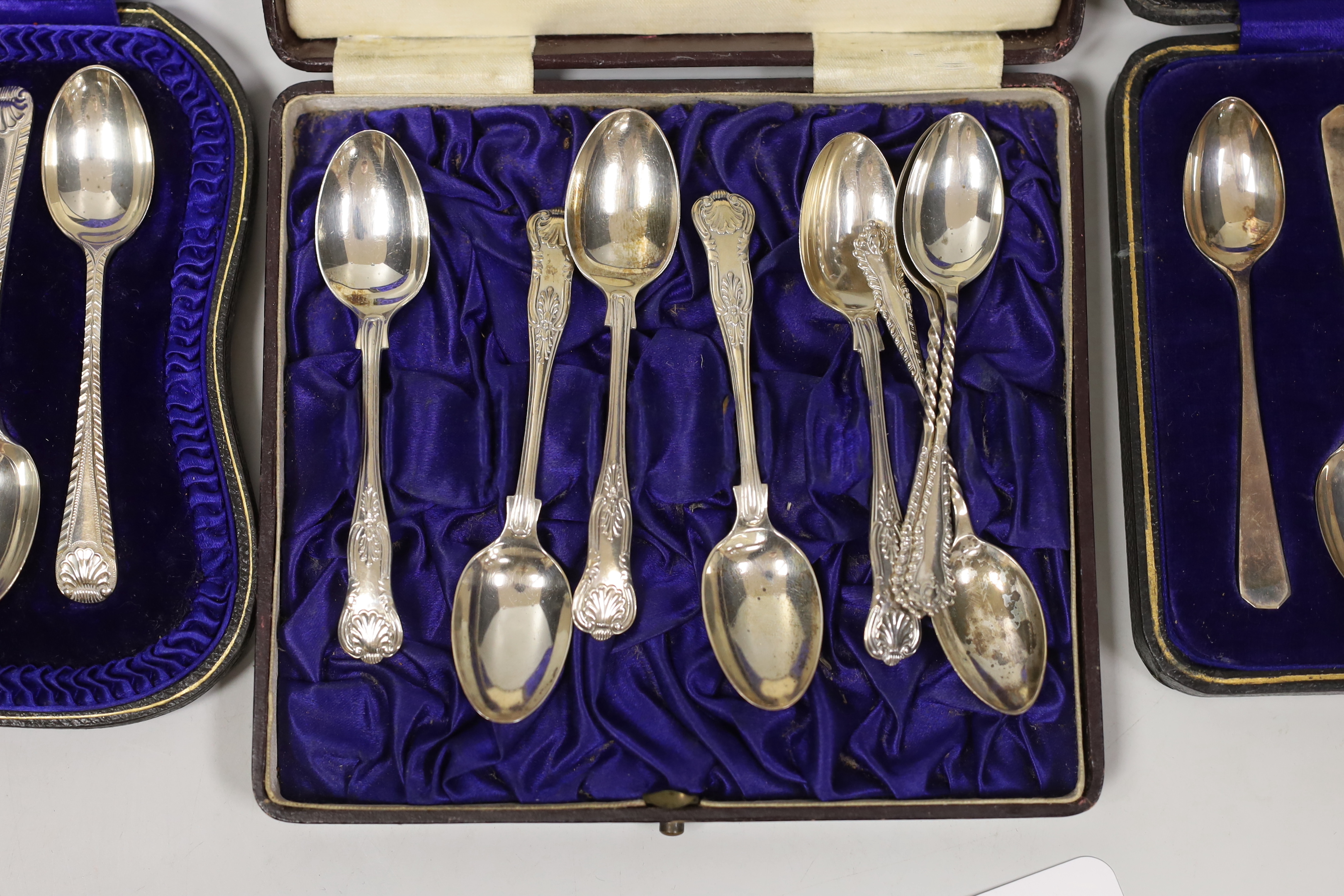 Three assorted cased sets of six silver tea or coffee spoons, one with tongs and other incomplete set.